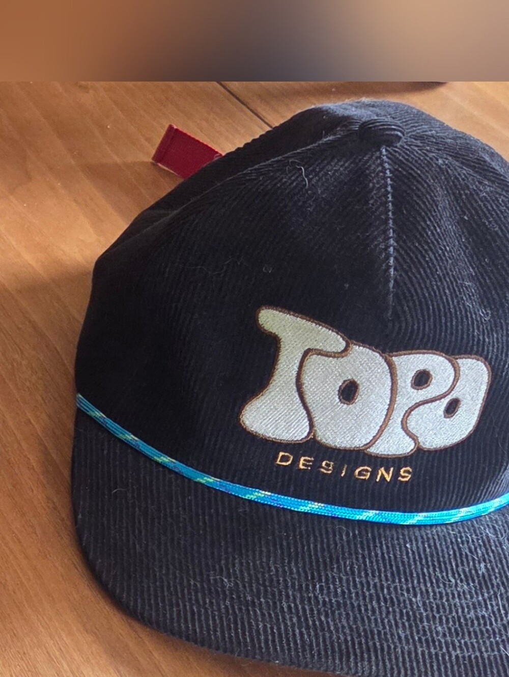 Topo Designs Black Corduroy Cap with Teal Trim and White Logo